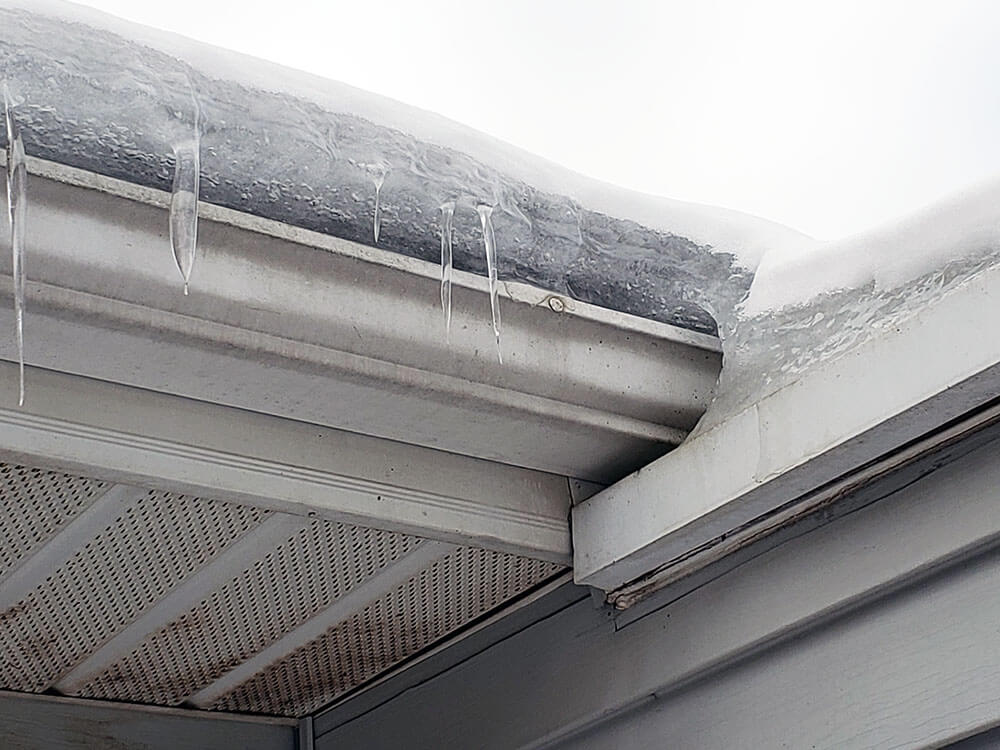 ice dam in the gutter of a house in grand rapids, mi